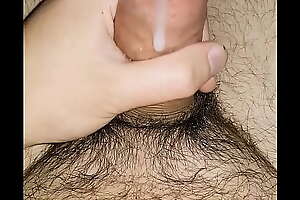 Young hairy guy cums on his pubes